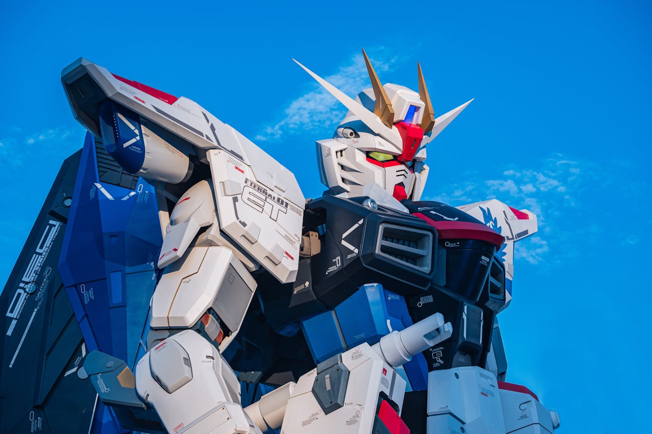 gallery-01 Close-up of a giant Gundam robot statue set against a clear blue sky.
